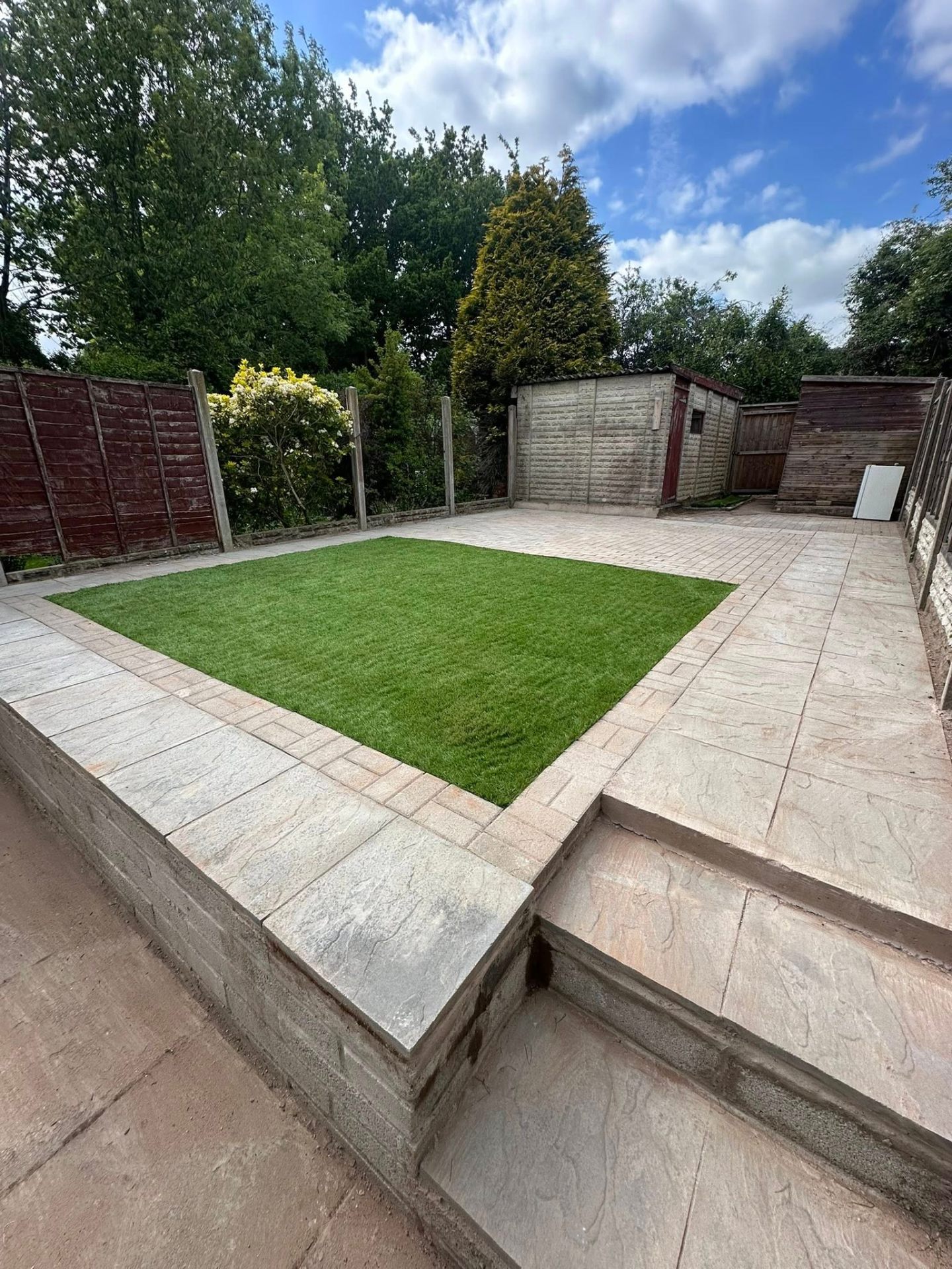 Paved patio with fresh lawn