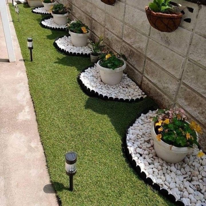 Garden border with planters and pebbles